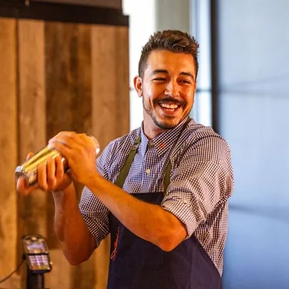 Happy team member mixing a drink