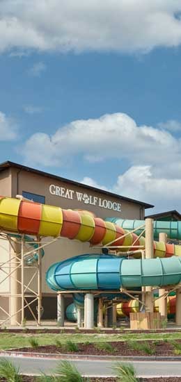 Photo of the outside of Great Wolf Lodge where the slides are coming out of the building.