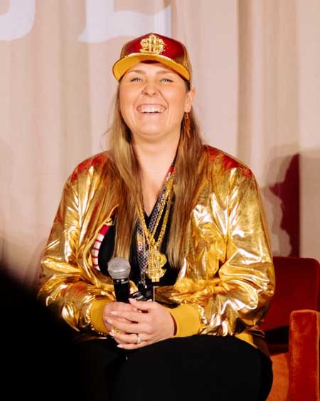 Pack member on stage with microphone in hand