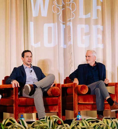 Two pack members on stage speaking
